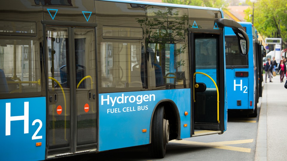 A hydrogen fuel cell buses stands at the station